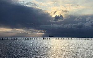 Sunlight breaking through storm clouds over the lake
