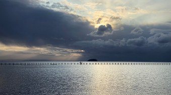 Sunlight breaking through storm clouds over the lake