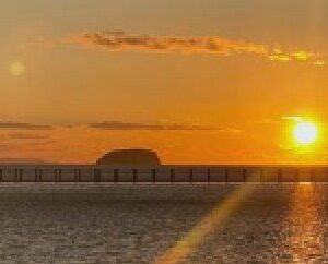 The sun setting over the Bristol Channel beyond the causeway