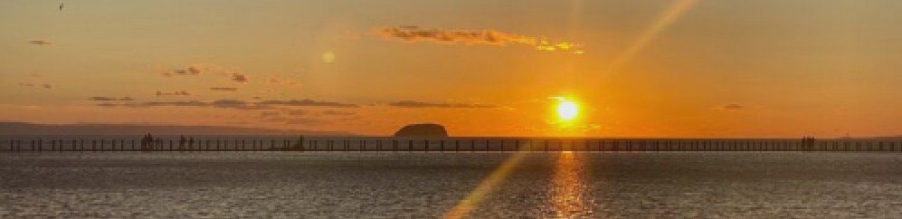 The sun setting over the Bristol Channel beyond the causeway